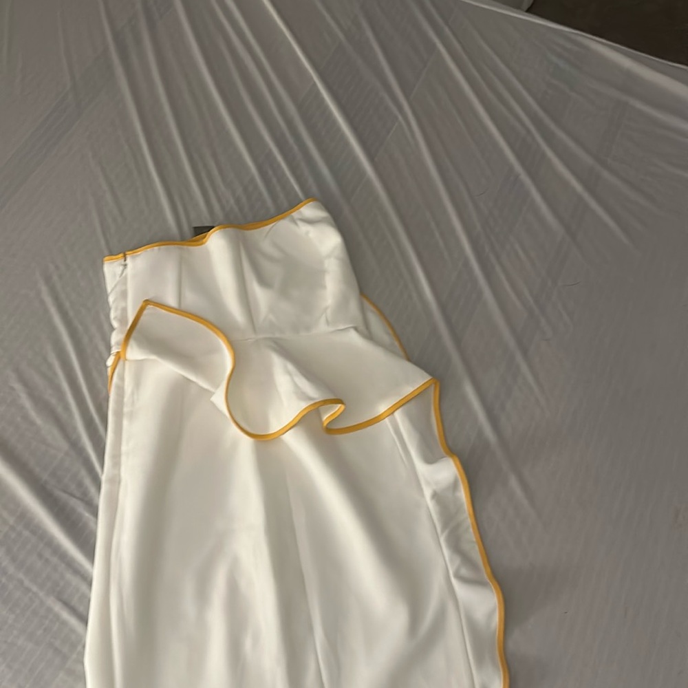 Asymmetrical cream coloured dress with yellow trimmed ruffle